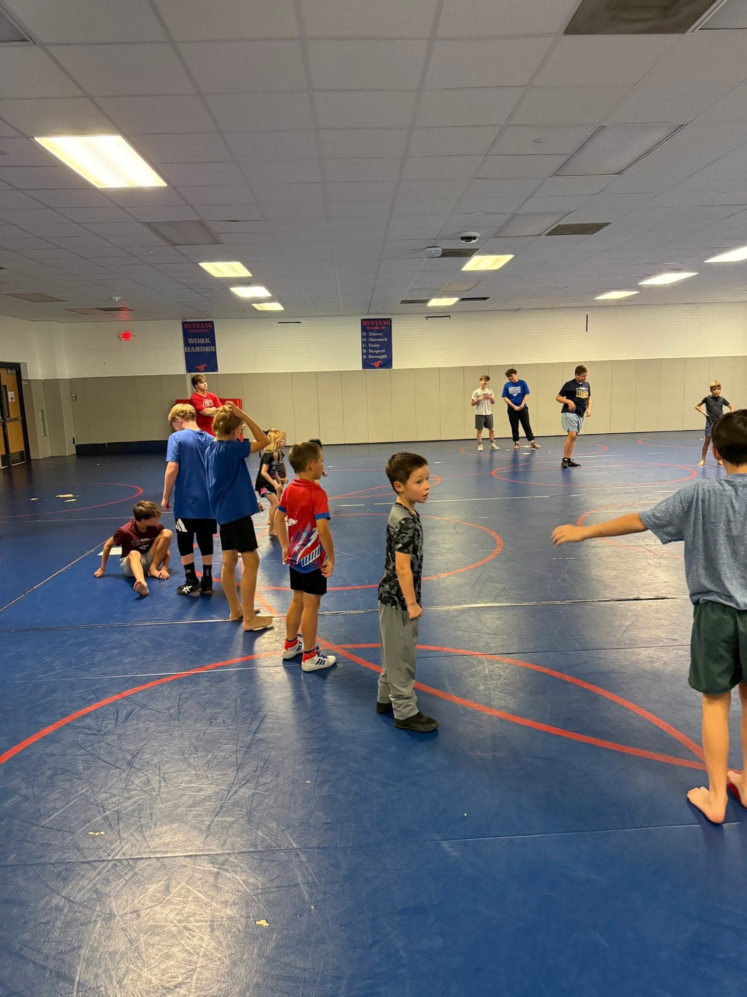 Mustang Elite wrestlers lined up and drilling during a practice session